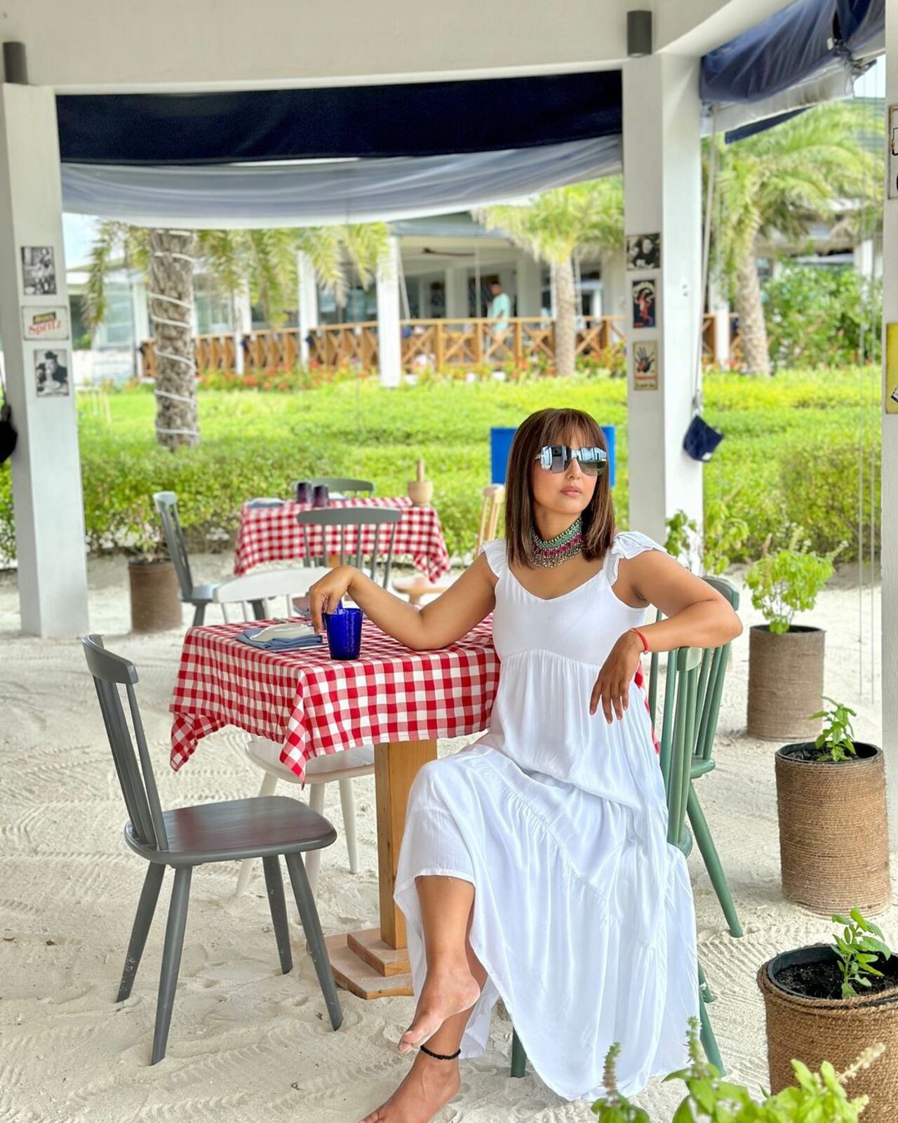 Hina looks gorgeous in a simple white dress for a meal near the beach